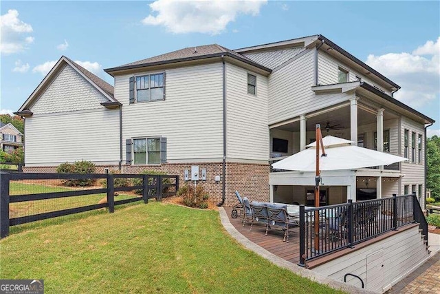 rear view of house featuring a lawn and outdoor lounge area