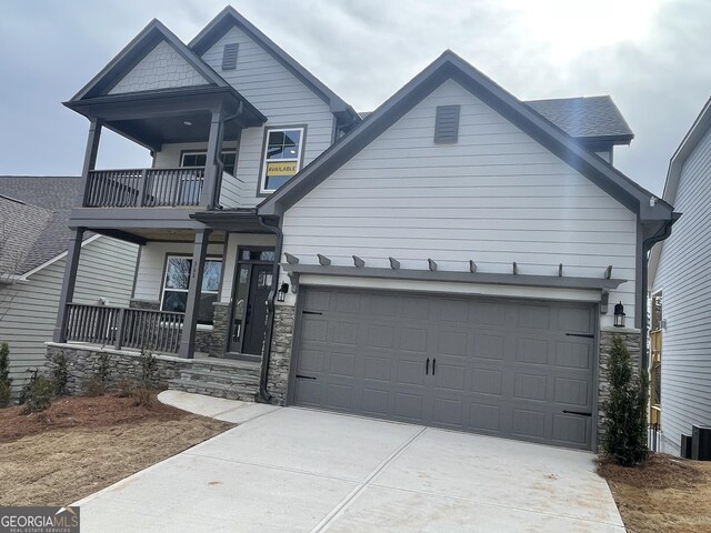 view of front of home featuring a balcony, cooling unit, and covered porch