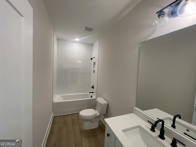 full bathroom featuring vanity, hardwood / wood-style floors,  shower combination, and toilet