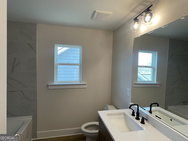 bathroom featuring vanity and toilet