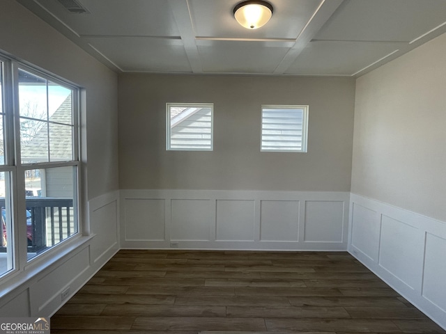 unfurnished room featuring coffered ceiling and dark hardwood / wood-style floors