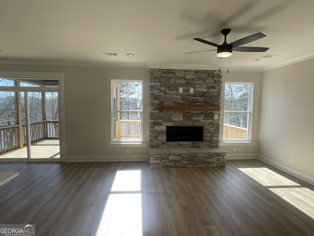 unfurnished living room featuring crown molding, ceiling fan, a fireplace, and dark hardwood / wood-style flooring