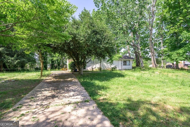 view of property hidden behind natural elements with a front yard