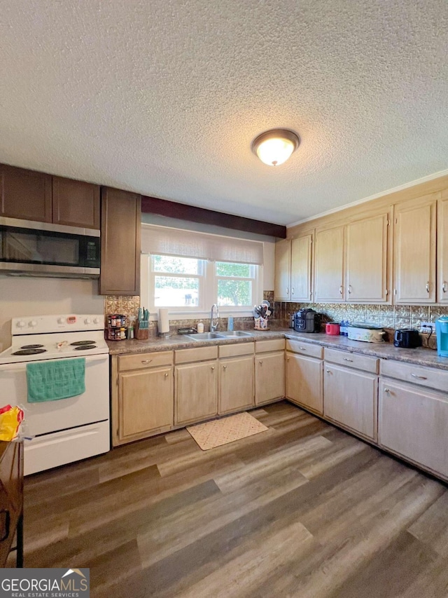 kitchen featuring dark wood-type flooring, sink, electric range, decorative backsplash, and a textured ceiling