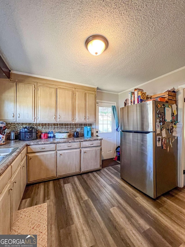 kitchen featuring stainless steel fridge, backsplash, a textured ceiling, dark wood-type flooring, and light brown cabinets