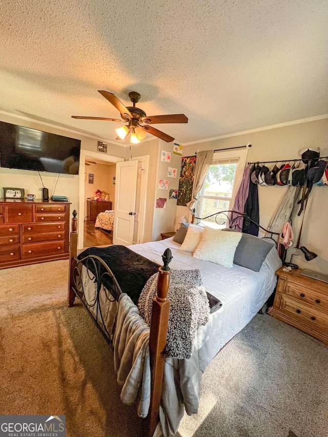 carpeted bedroom with a textured ceiling and ceiling fan