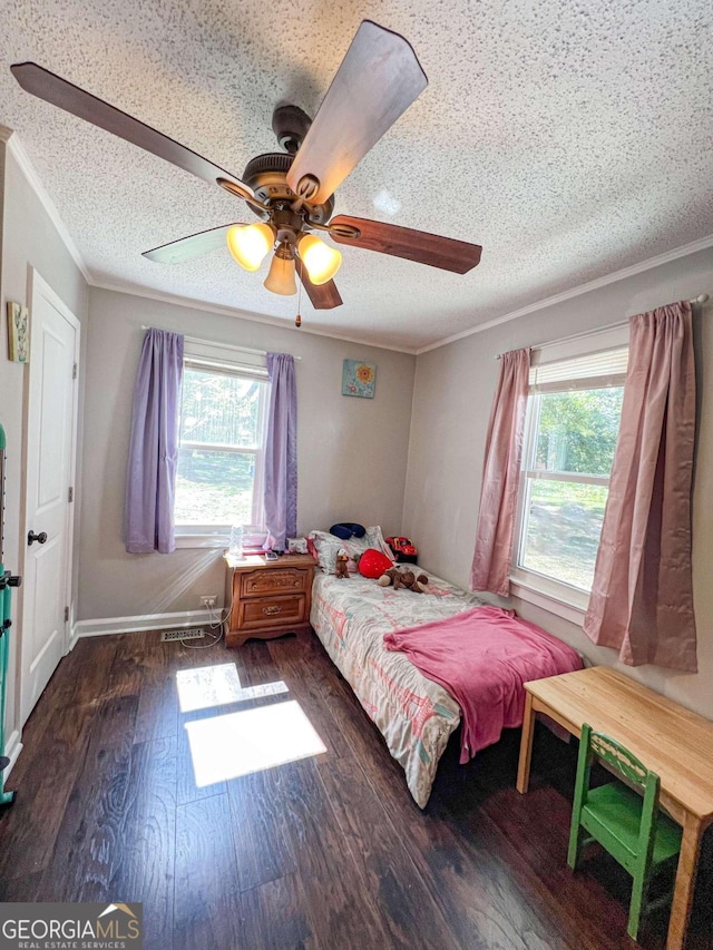 unfurnished bedroom featuring multiple windows, ceiling fan, dark wood-type flooring, and ornamental molding