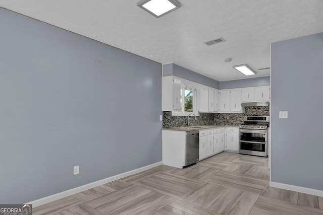 kitchen with stainless steel appliances, white cabinetry, sink, tasteful backsplash, and a textured ceiling