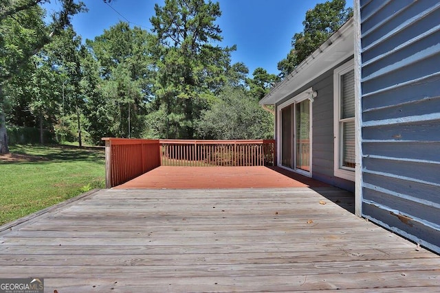 wooden deck with a lawn