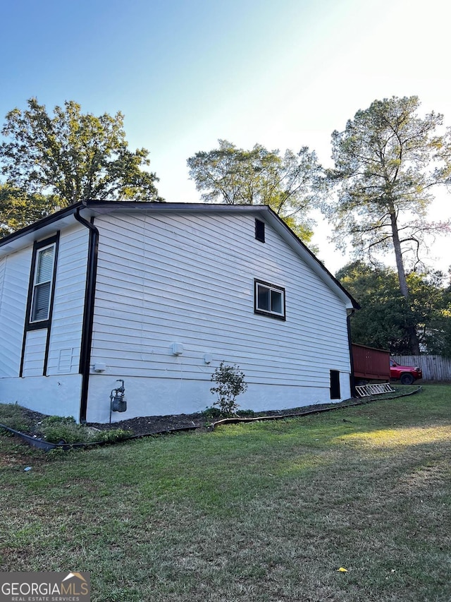 view of side of property with a lawn
