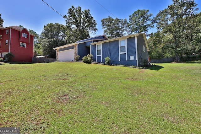 view of front of property with a garage and a front lawn