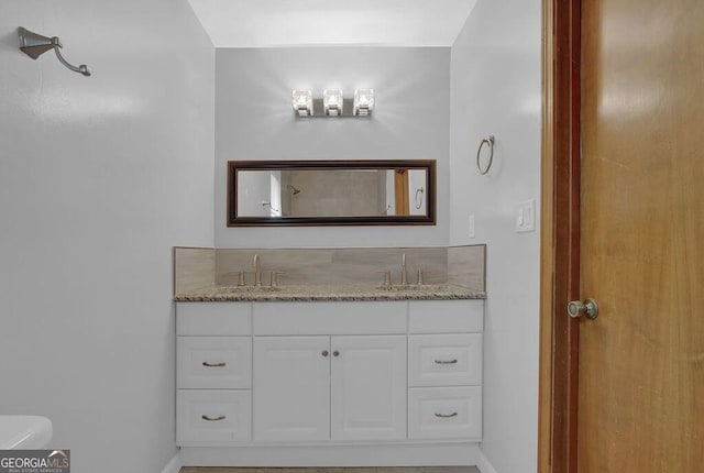 bathroom featuring toilet and vanity