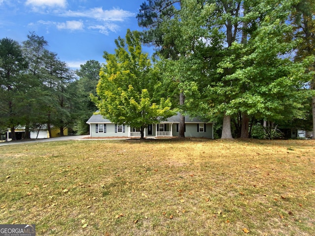 view of front facade with covered porch and a front lawn