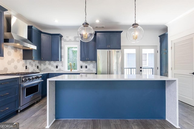 kitchen featuring a center island, wall chimney exhaust hood, dark hardwood / wood-style flooring, and high quality appliances