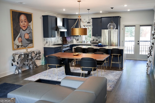 dining space featuring french doors, ornamental molding, and dark hardwood / wood-style flooring