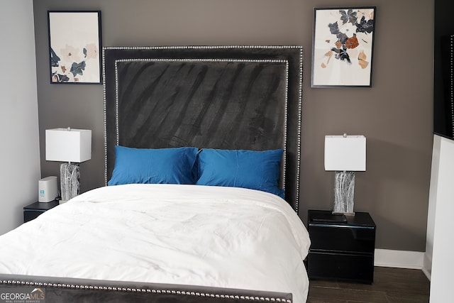 bedroom with dark wood-type flooring