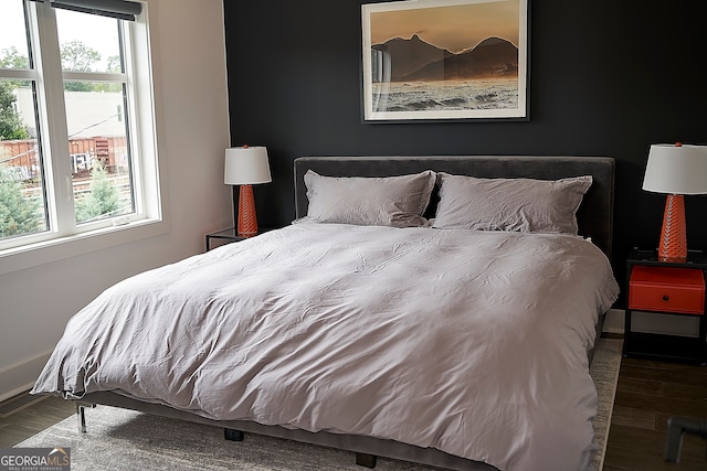 bedroom with dark hardwood / wood-style floors