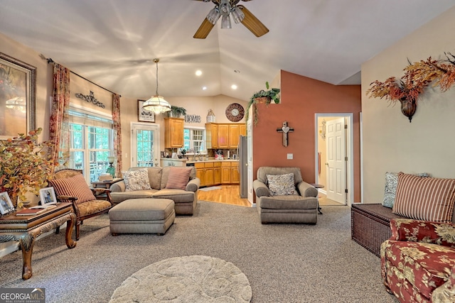 living room featuring ceiling fan, sink, light carpet, and vaulted ceiling