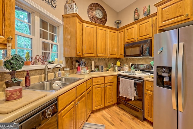 kitchen with stainless steel fridge, electric range oven, dishwashing machine, sink, and light hardwood / wood-style flooring