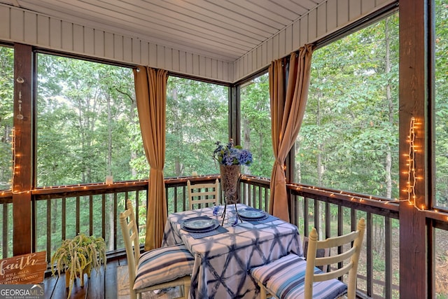 unfurnished sunroom with wooden ceiling