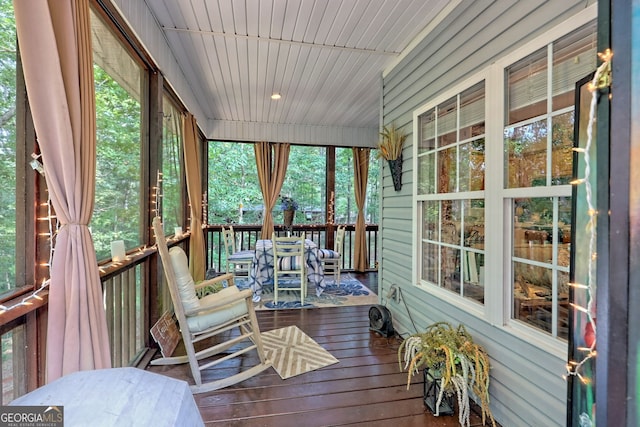 sunroom with a healthy amount of sunlight and wood ceiling