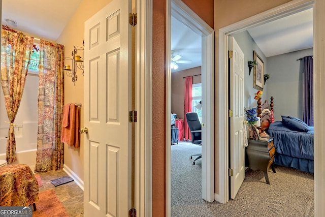 hall with light colored carpet and vaulted ceiling