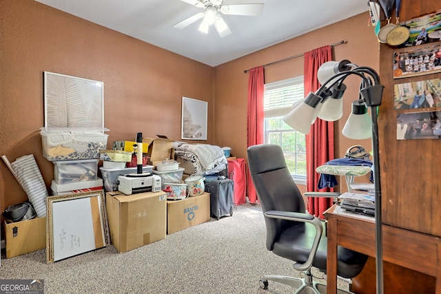 carpeted office space featuring ceiling fan