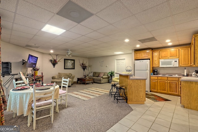 tiled living room with a paneled ceiling