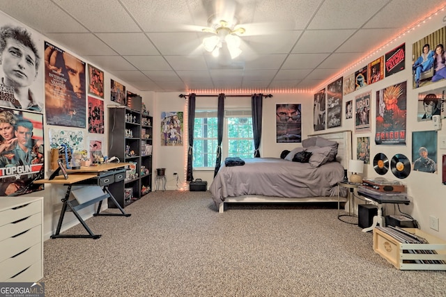 carpeted bedroom featuring a paneled ceiling and ceiling fan