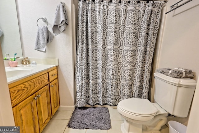 bathroom featuring tile patterned floors, vanity, toilet, and walk in shower