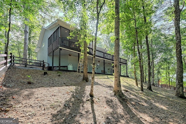 rear view of property with a sunroom