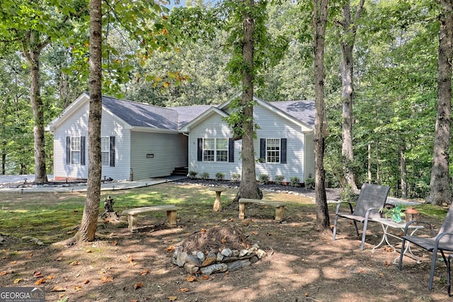 rear view of house featuring a fire pit