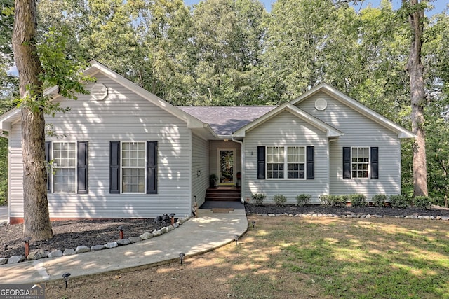 single story home featuring a front yard