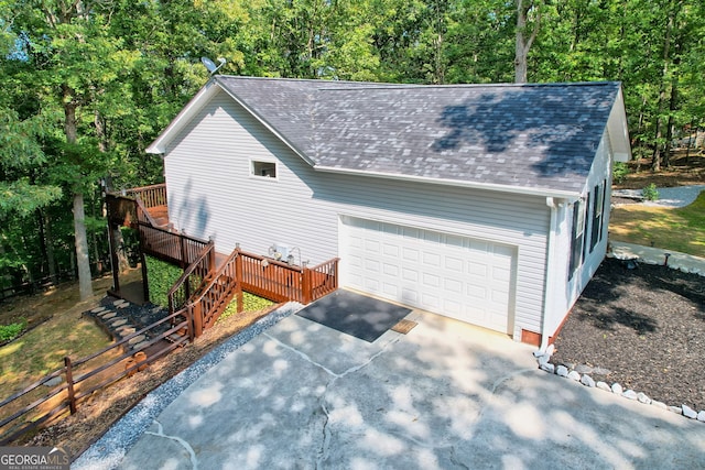 view of side of home with a deck and a garage