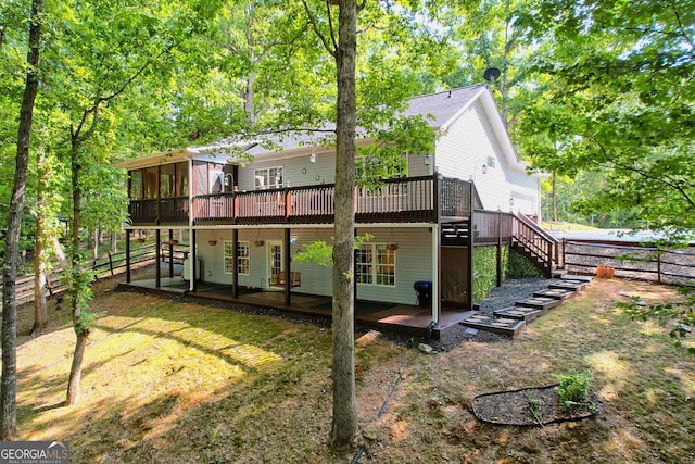 rear view of property with a lawn, a patio, and a wooden deck