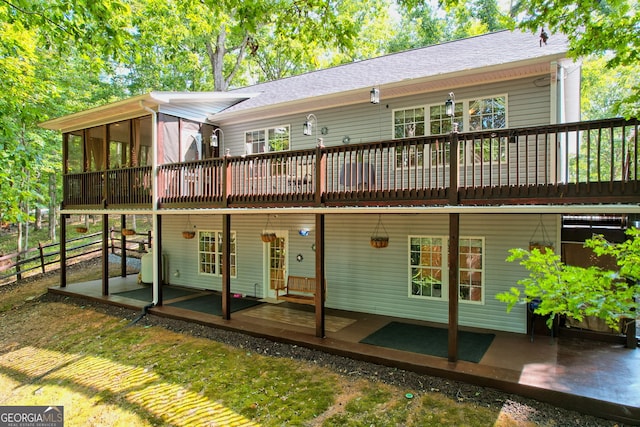 rear view of house featuring a deck and a patio