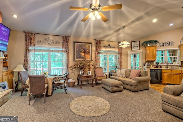 living room featuring light colored carpet, a wealth of natural light, and ceiling fan