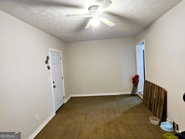 interior space with a textured ceiling and ceiling fan