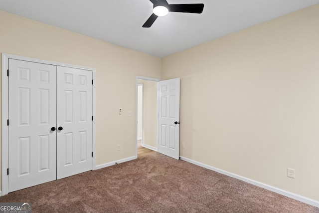 unfurnished bedroom featuring ceiling fan, a closet, baseboards, and carpet flooring