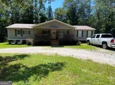 view of front of home featuring covered porch and a front yard