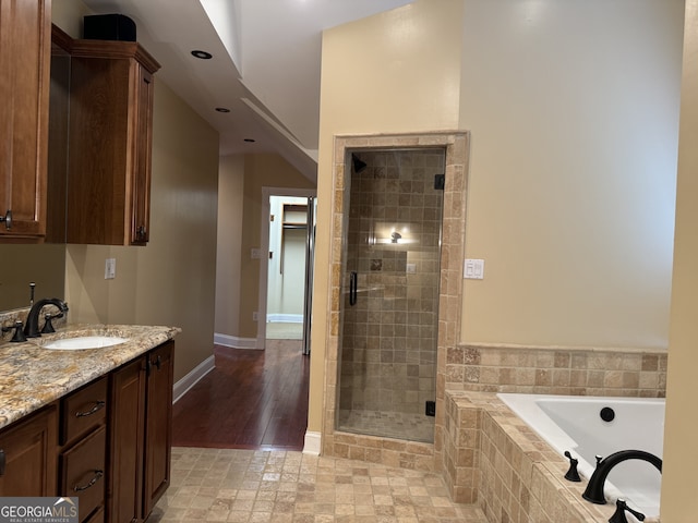 490 Hill St SE, Atlanta, GA 30312 - bathroom featuring hardwood / wood-style floors, independent shower and bath, and vanity