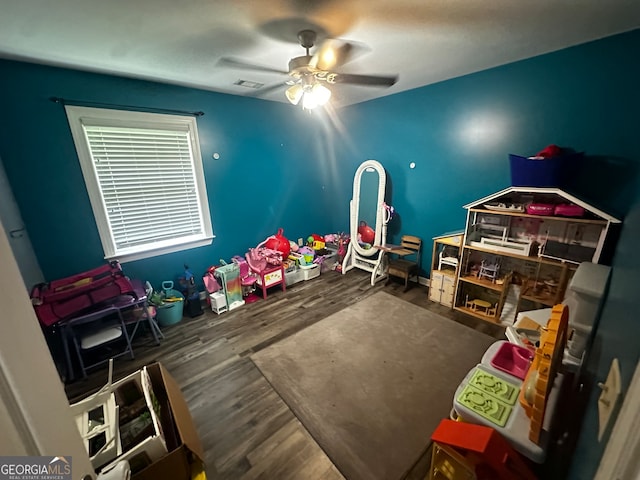 recreation room with dark hardwood / wood-style flooring and ceiling fan