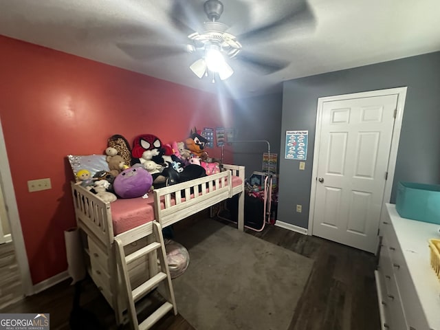 bedroom with ceiling fan and dark hardwood / wood-style floors