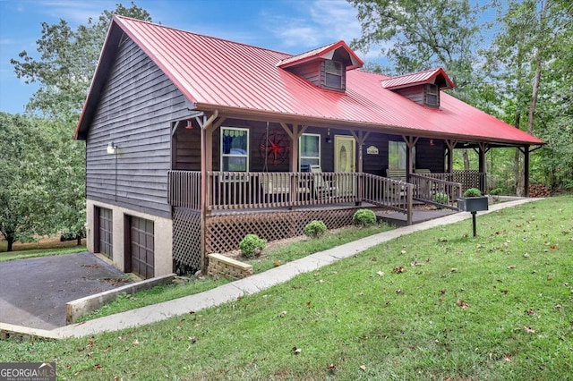 view of front of house with a garage, a front yard, and covered porch