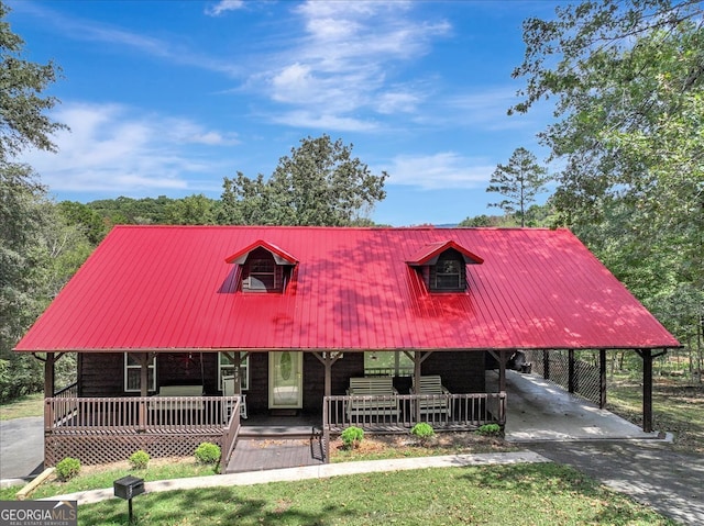 cape cod house with a porch and a carport