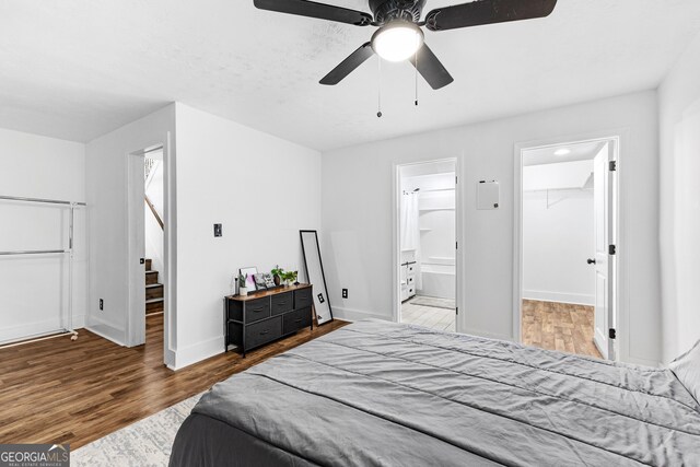 bedroom featuring wood-type flooring, connected bathroom, a spacious closet, and a closet