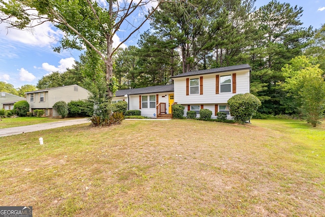 split level home featuring a front lawn