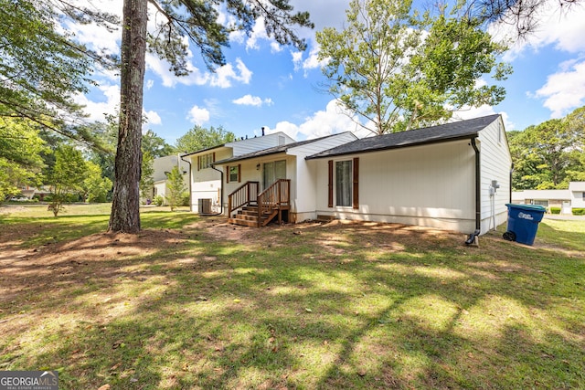 back of property featuring a lawn