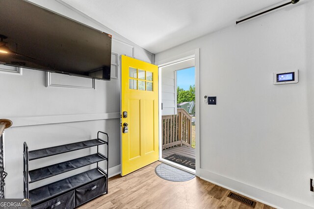 entryway featuring lofted ceiling and wood-type flooring