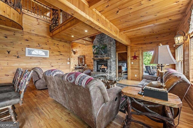 living room featuring wooden walls, a fireplace, and hardwood / wood-style flooring